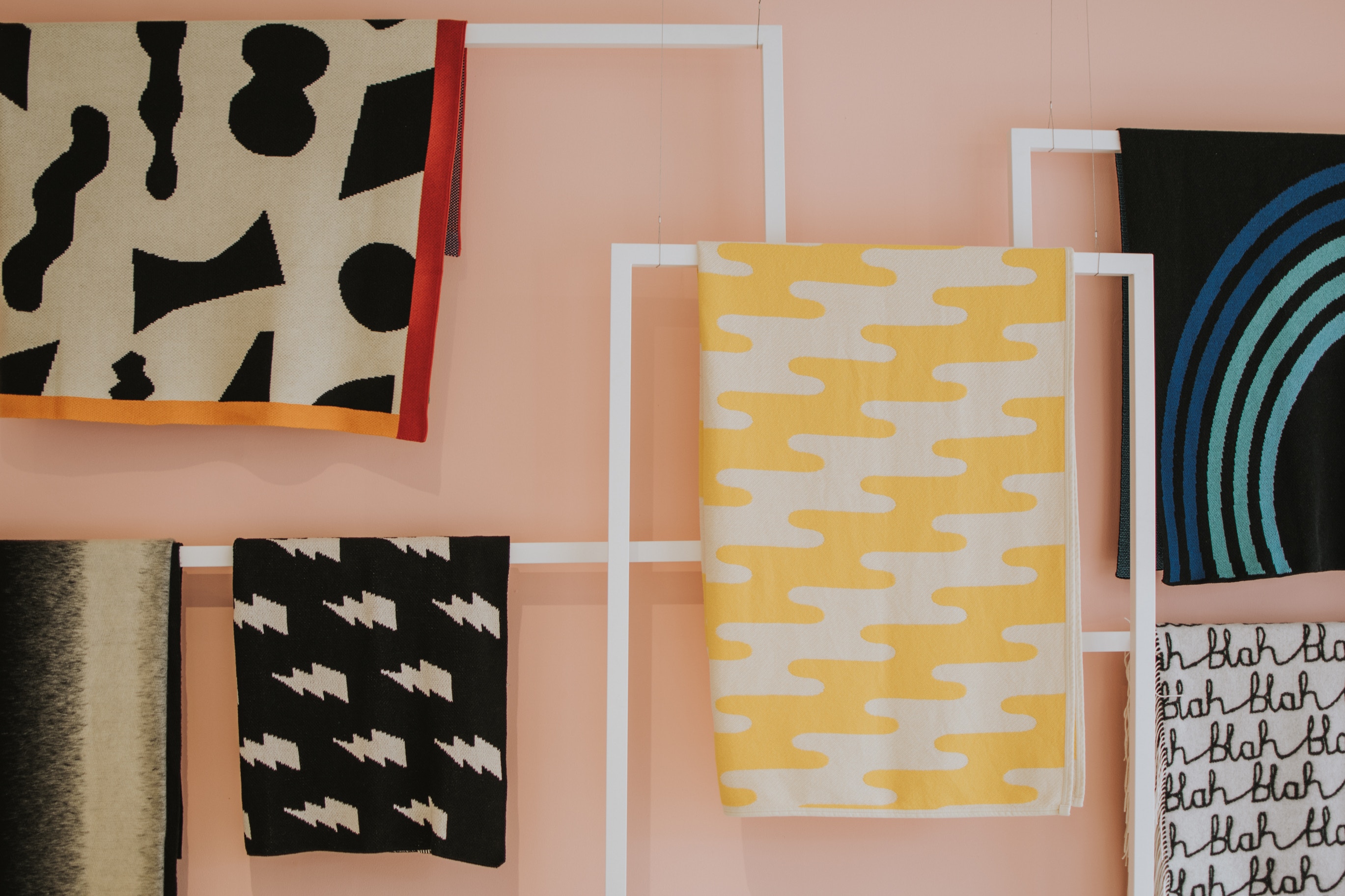 Pieces of brightly coloured cloth curated into geometric wall art as part of creative branding exercise