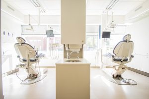 Image from the back of orthodontist Glasgow clinic showing two patient chairs and some equipment